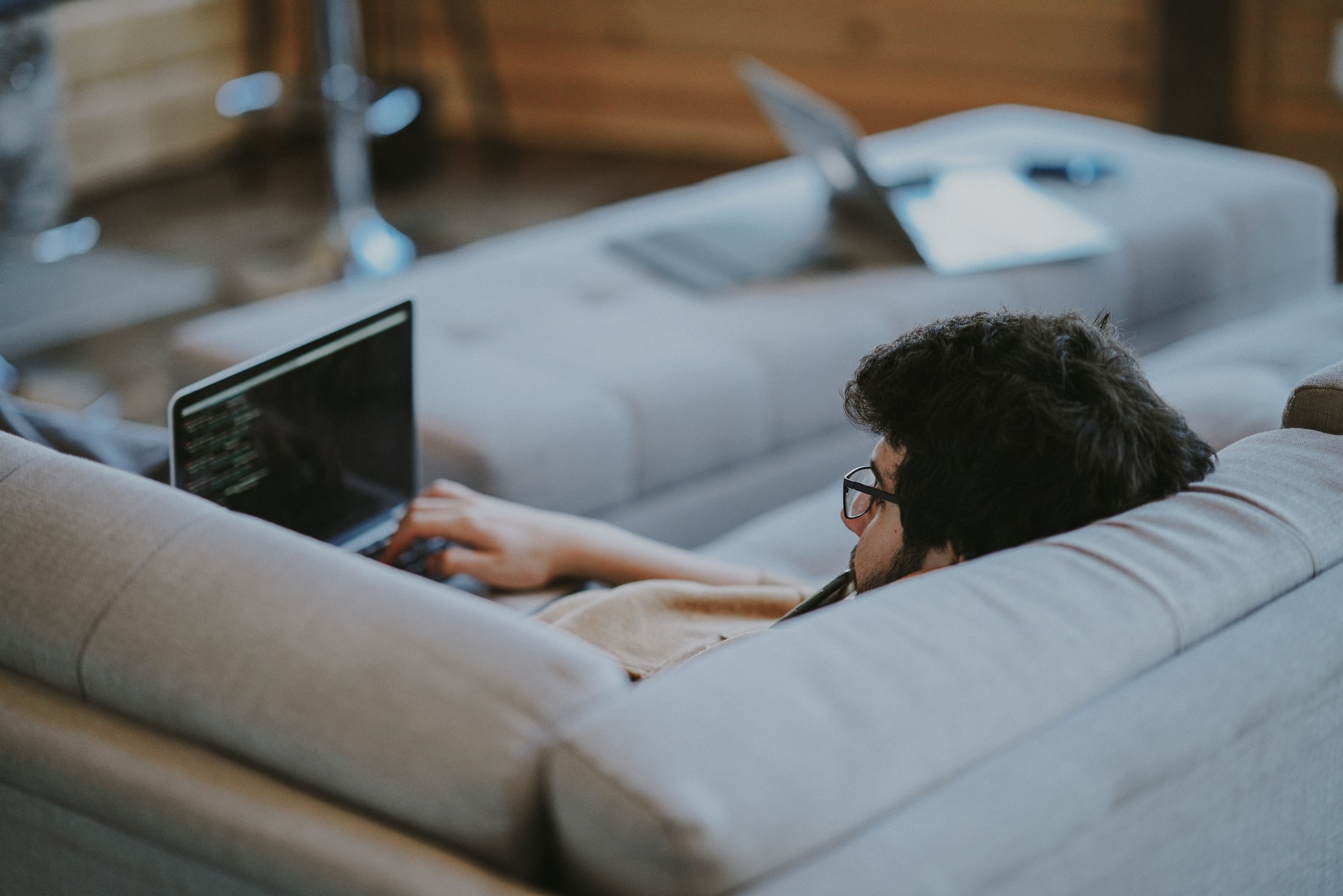 Low code developer sitting in his couch working